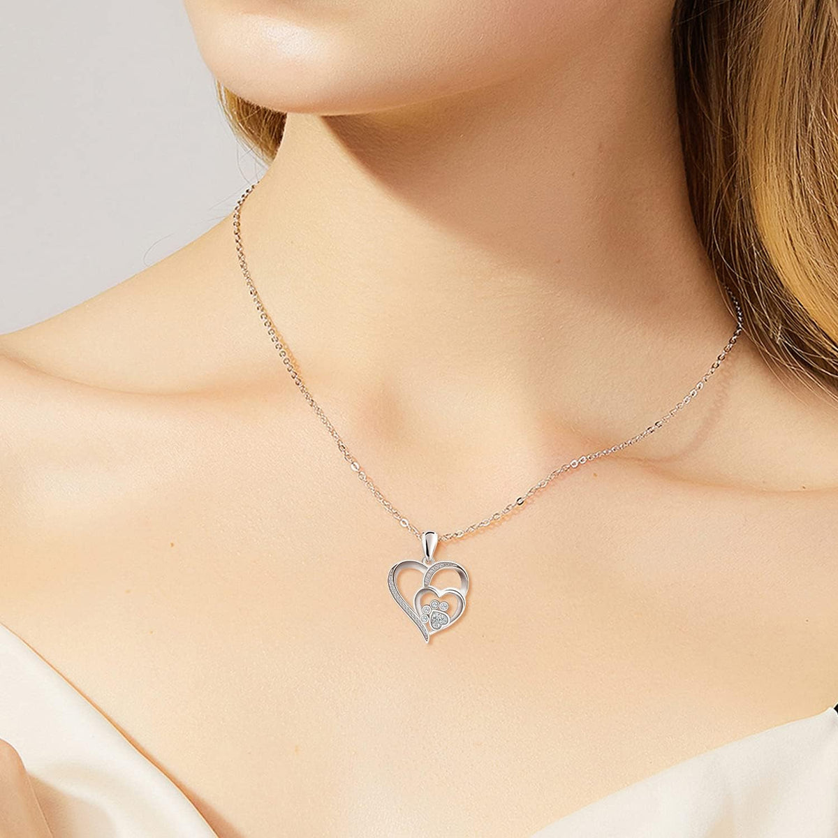 Sterling silver necklace with paw print and heart, set with zirconia.