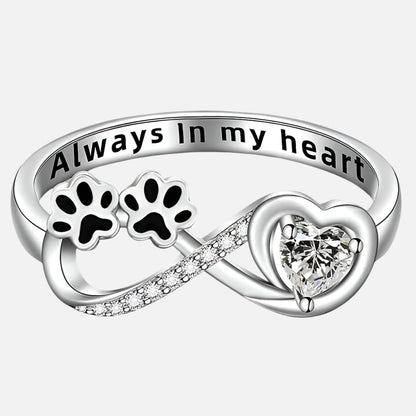Ring with paw-shaped zirconia stones, heart and infinity symbol.